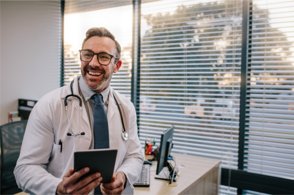 male doc in office smiling-flipped